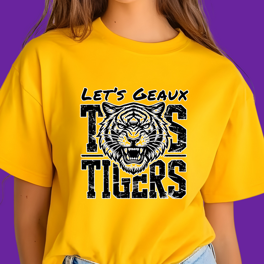 Person wearing a yellow t-shirt with 'Let's Geaux Tigers' design on a purple background Let's Geaux Tigers T-Shirt - Fierce Tiger Graphic Game Day Tee