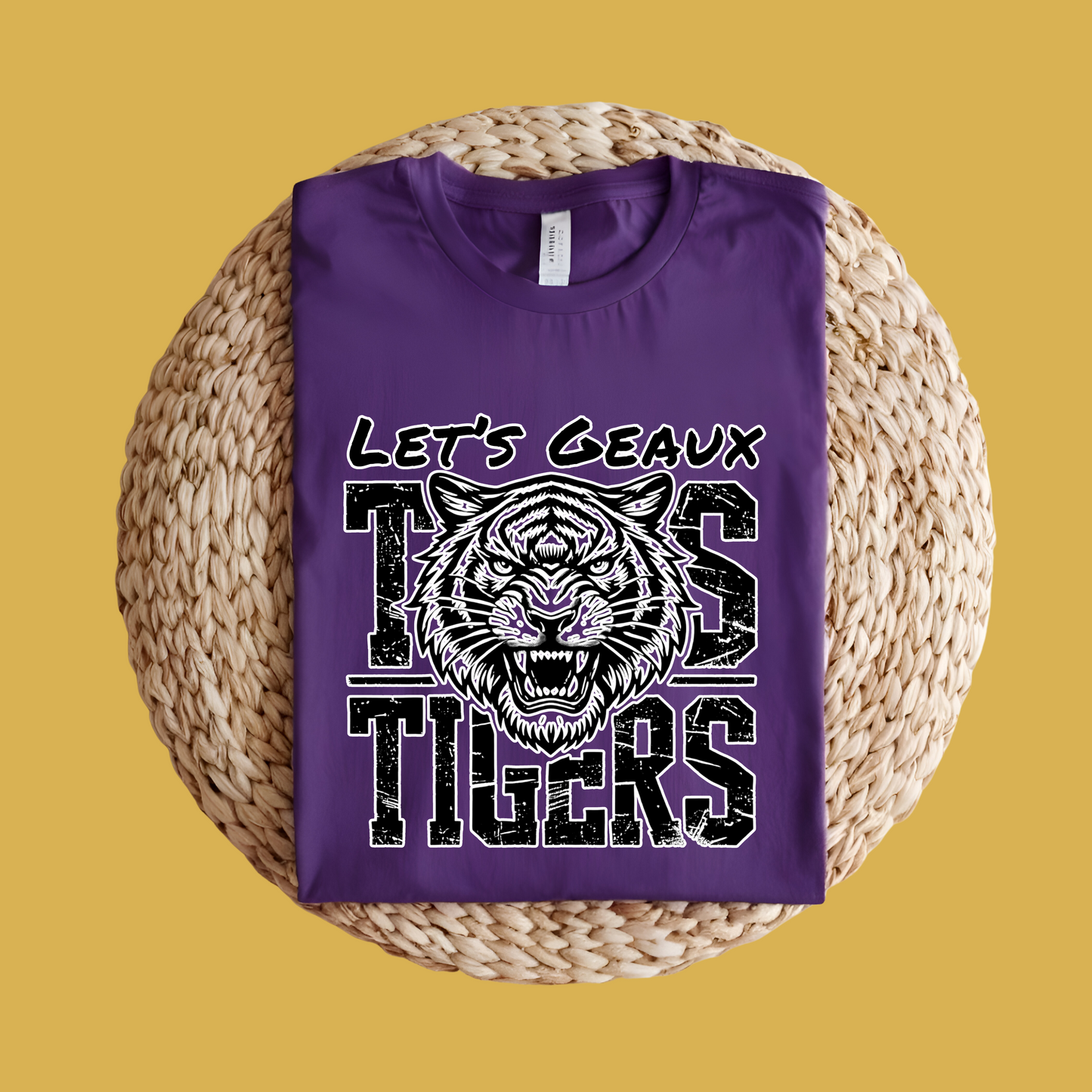 Purple t-shirt with tiger graphic and text on a woven surface Let's Geaux Tigers T-Shirt - Fierce Tiger Graphic Game Day Tee