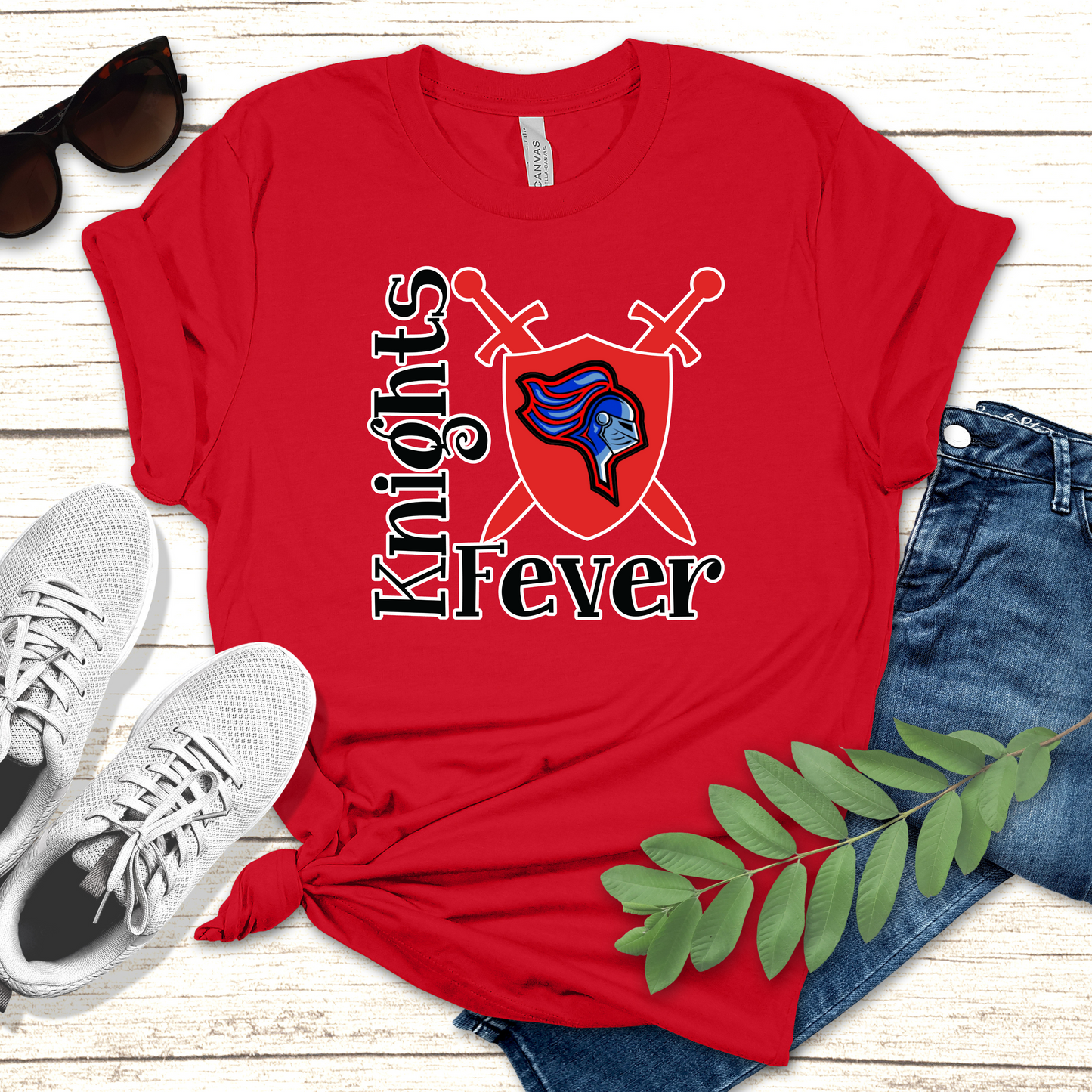 Red t-shirt with 'Knights Fever' design on a wooden surface with shoes and jeans. Knights School Spirit Shirt - Knights Fever - Rep the Knights Tee