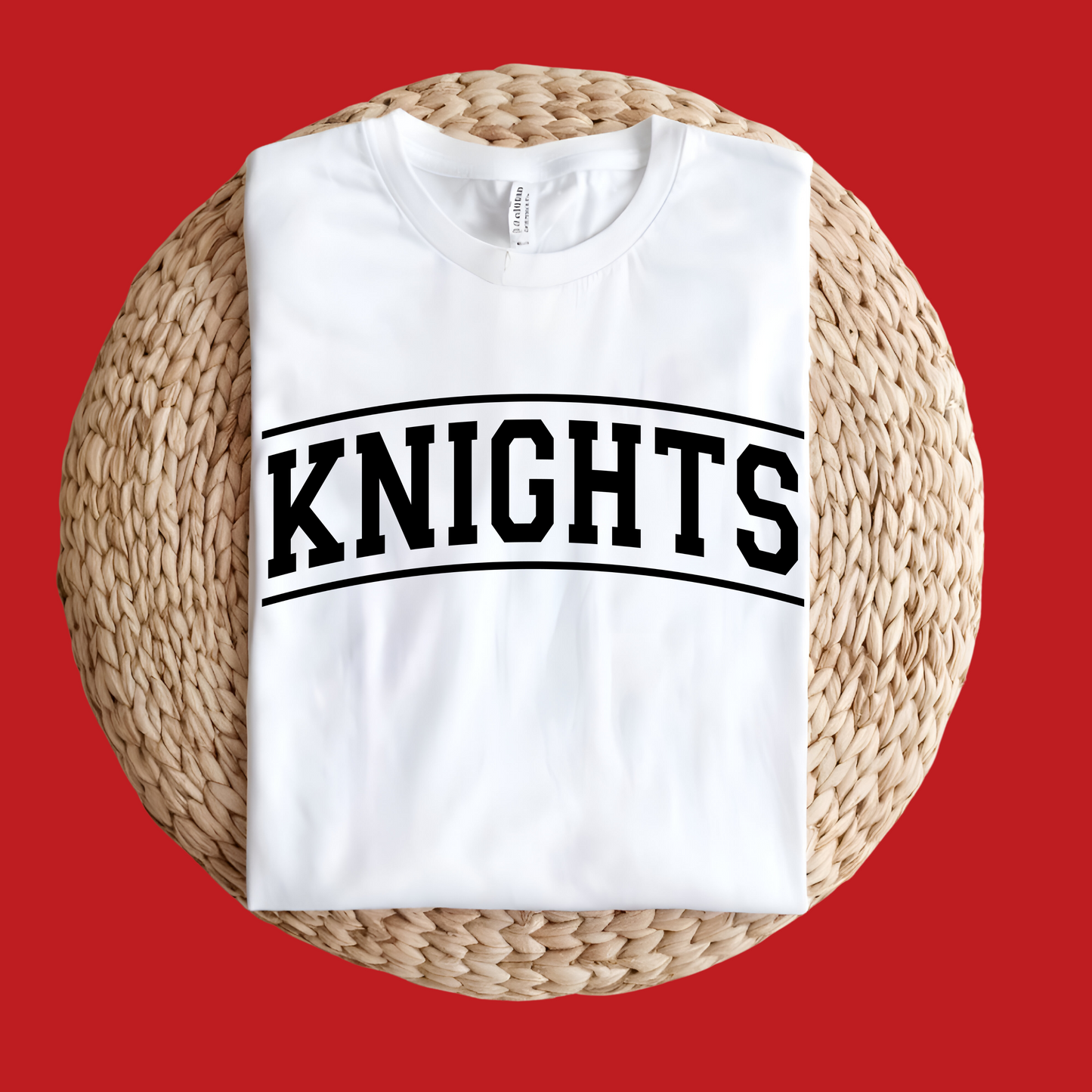 White tank top with 'KNIGHTS' text on a woven stool against a red background Knights School Spirit Shirt - Knights Fan Merch - School Pride Graphic T-Shirt