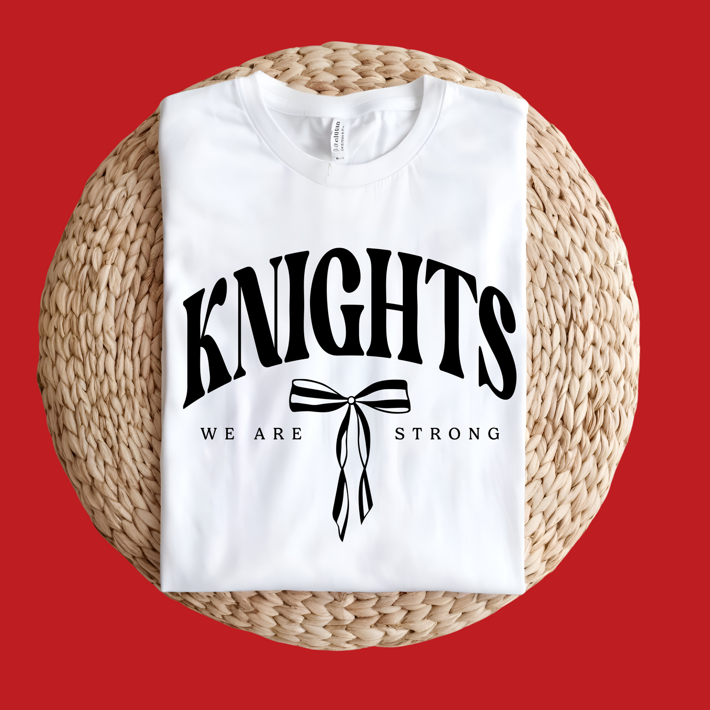 White t-shirt with 'KNIGHTS WE ARE STRONG' text on a woven surface with red background Knights School Spirit Shirt - Knights We Are Strong - Knights Spirit Tee