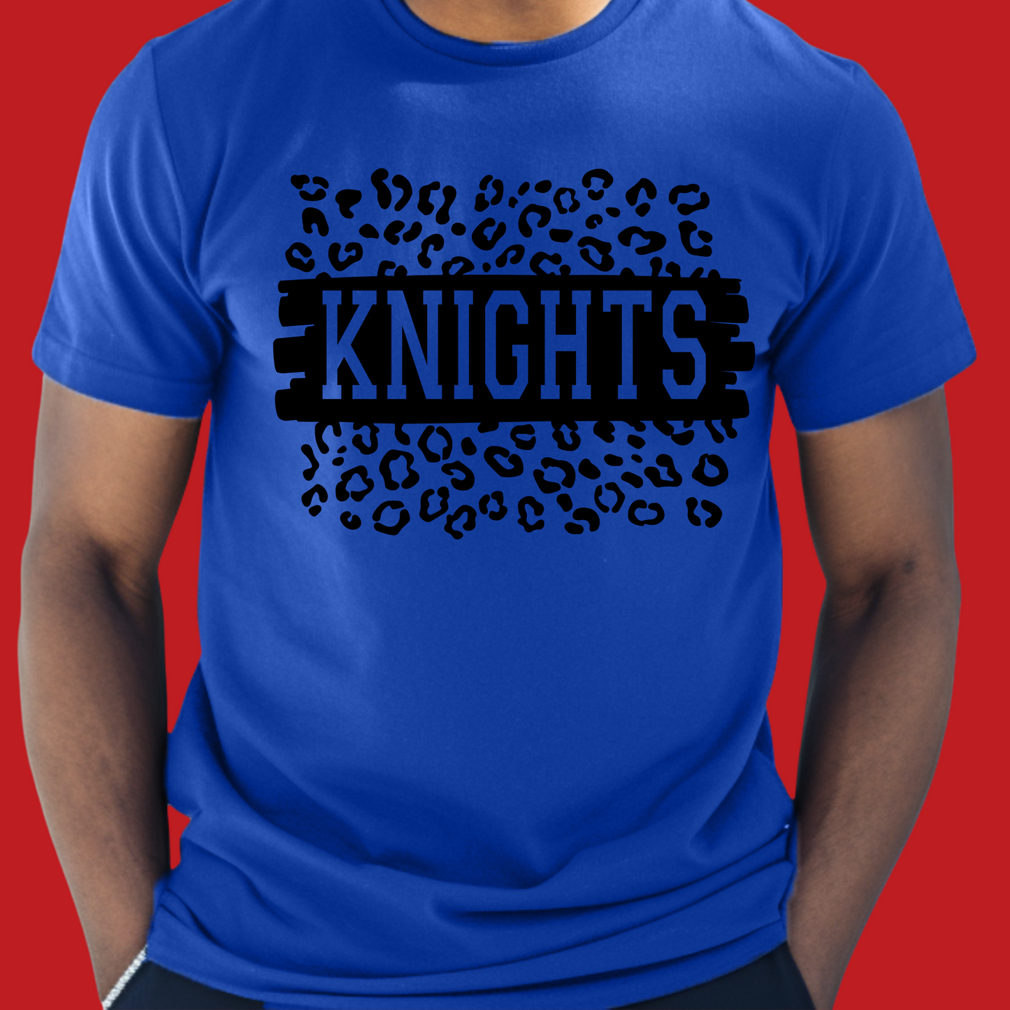 Person wearing a blue t-shirt with 'KNIGHTS' design on a red background Knights School Spirit Shirt - Knights Leopard - School Pride Graphic T-Shirt