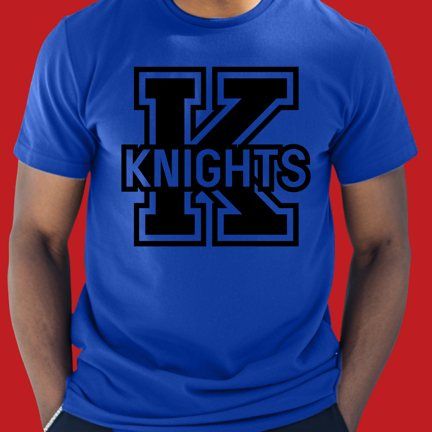 Person wearing a blue t-shirt with '12 KNIGHTS' printed on it against a red background Knights School Spirit Shirt - Knights Logo: Loud & Proud Knights