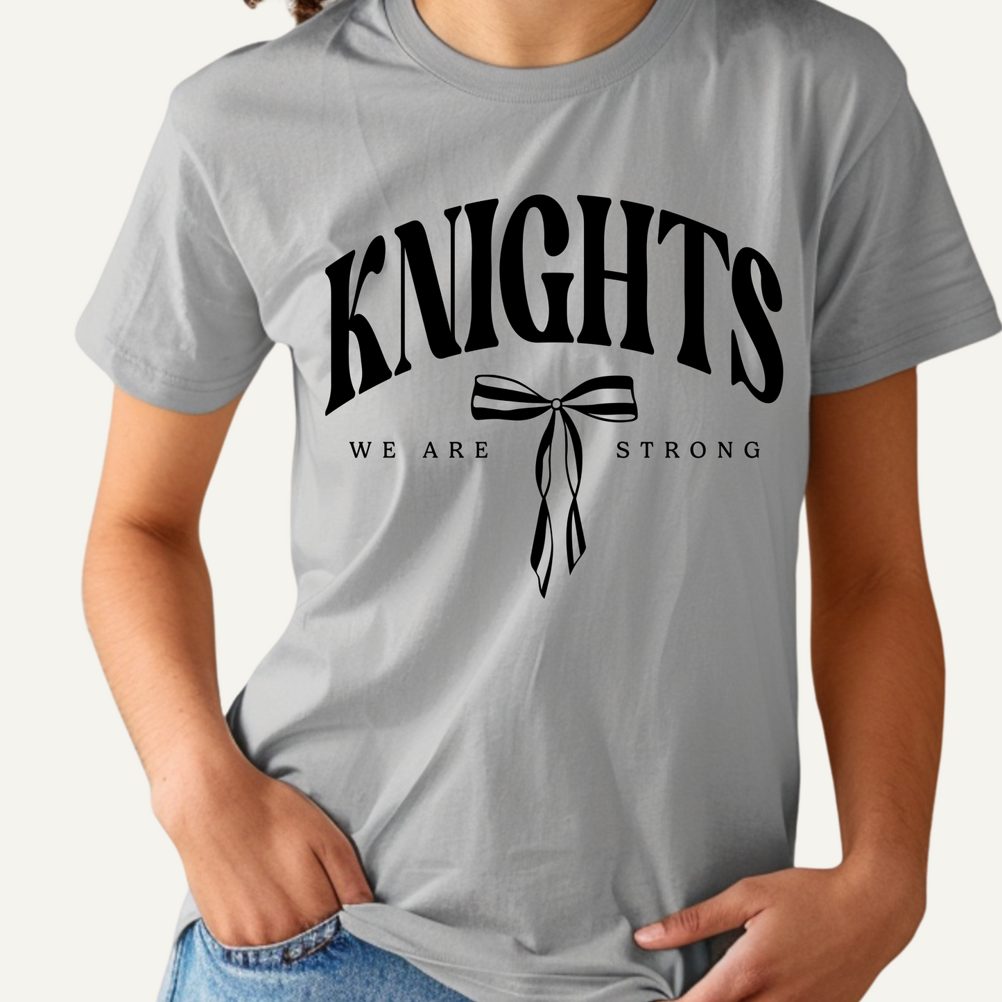 Gray t-shirt with 'KNIGHTS WE ARE STRONG' text and bow graphic on a plain background Knights School Spirit Shirt - Knights We Are Strong - Knights Spirit Tee