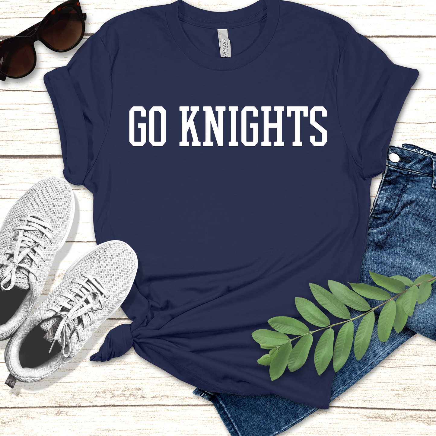 Navy blue t-shirt with 'GO KNIGHTS' text, paired with jeans, sneakers, and sunglasses on a wooden surface. Knights School Spirit Shirt - Go Knights - School Pride T-Shirt