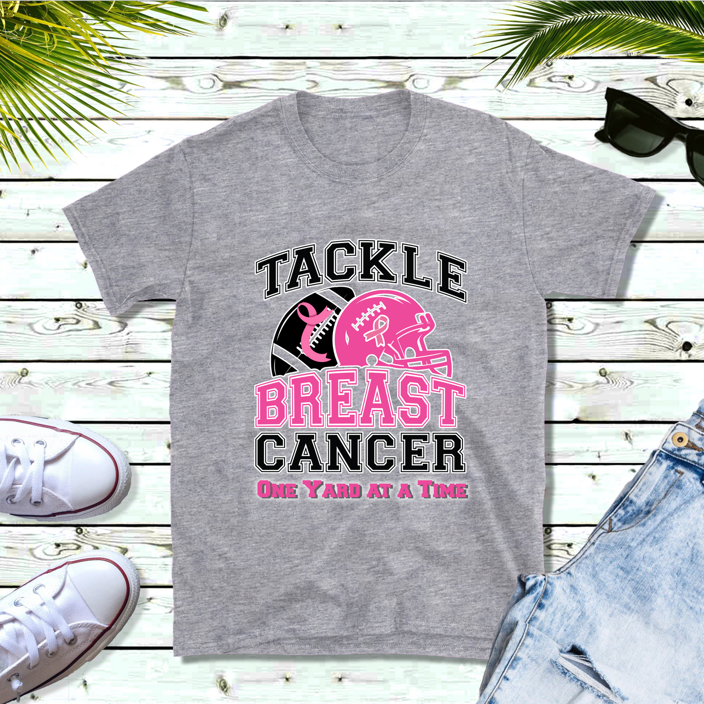 Gray t-shirt with 'Tackle Breast Cancer One Yard at a Time' design on a wooden surface with sneakers and shorts. October Awareness Shirt - Tackle for a Cause One Yard at a Time Tee