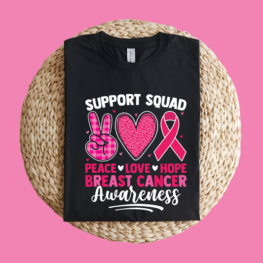 Black t-shirt with breast cancer awareness design on a pink background Pink Ribbon T-Shirt: Support Squad Peace Love Hope - Support Tee