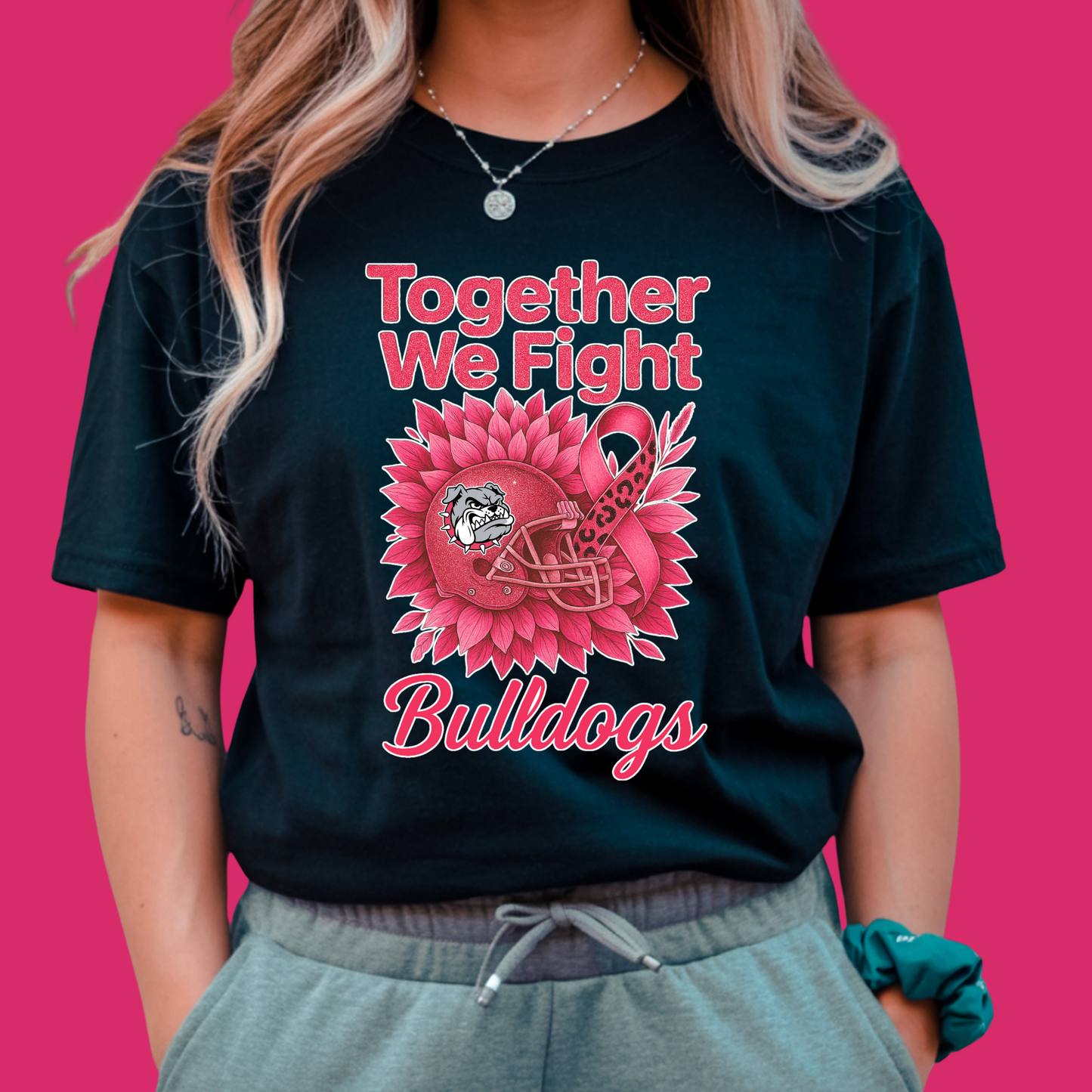 Person wearing a black t-shirt with pink bulldog graphic and text on a pink background Custom Pink Ribbon Football Tee: Together We Fight - Custom Mascot