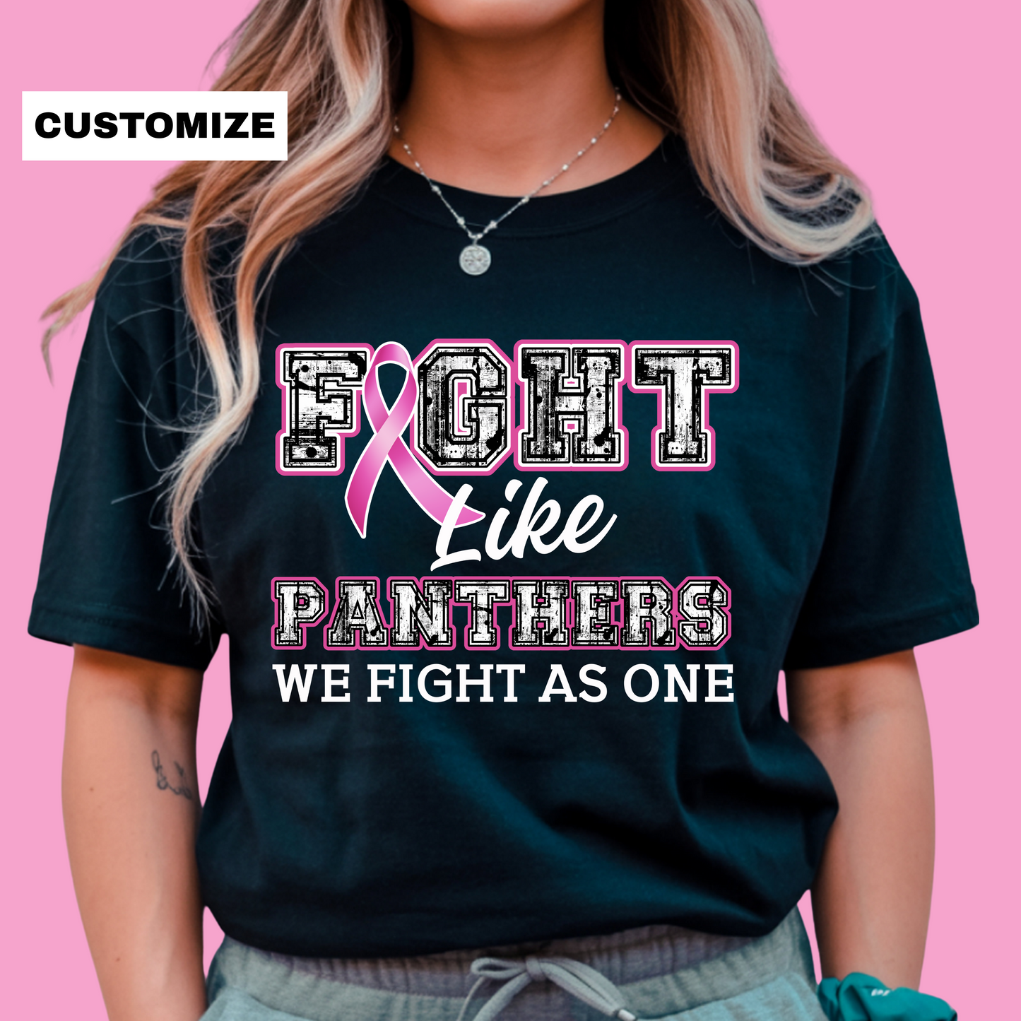 Person wearing a black t-shirt with a pink ribbon design and text on a pink background Custom Mascot T-Shirt: Fight Like a "Mascot" - Game Day Breast Cancer Support Tee