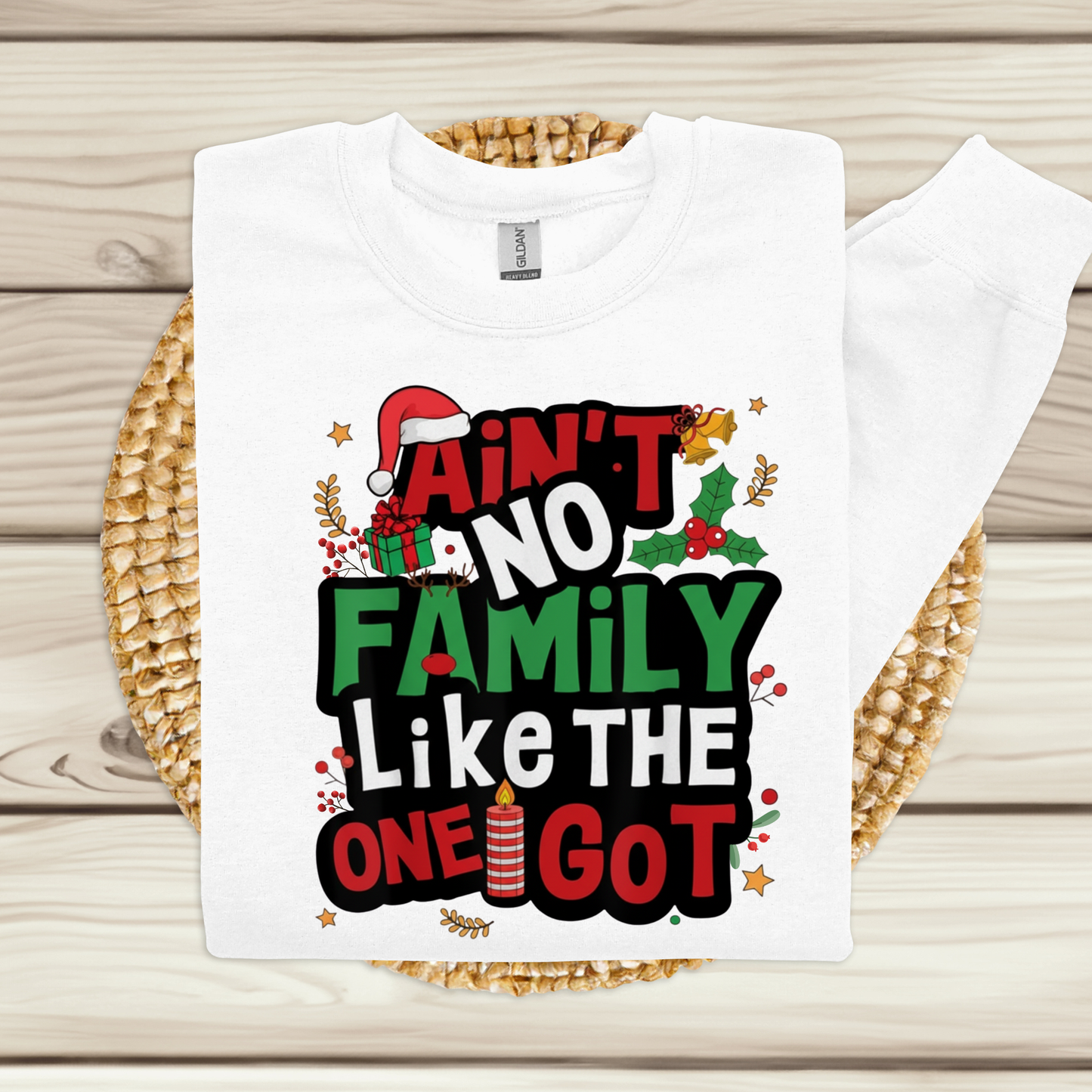 White t-shirt with Christmas-themed text design on a wooden surface