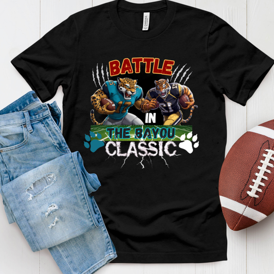 Black t-shirt with 'Battle in the Bayou Classic' graphic, paired with denim shorts and a football on a white background. Bayou Classic: Battle in the Bayou Classic Game Day Unisex T-Shirt