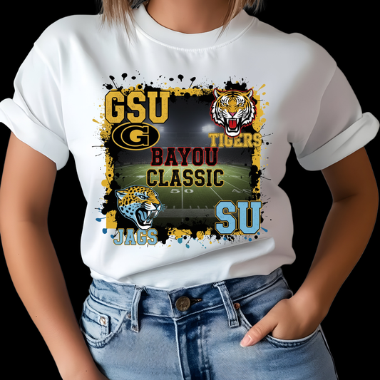 White t-shirt with sports-themed design featuring 'GSU Tigers' and 'SU Jags' on a black background. Bayou Classic Football T-Shirt - Grambling State GSU Tigers vs. Southern University SU Jags Tee
