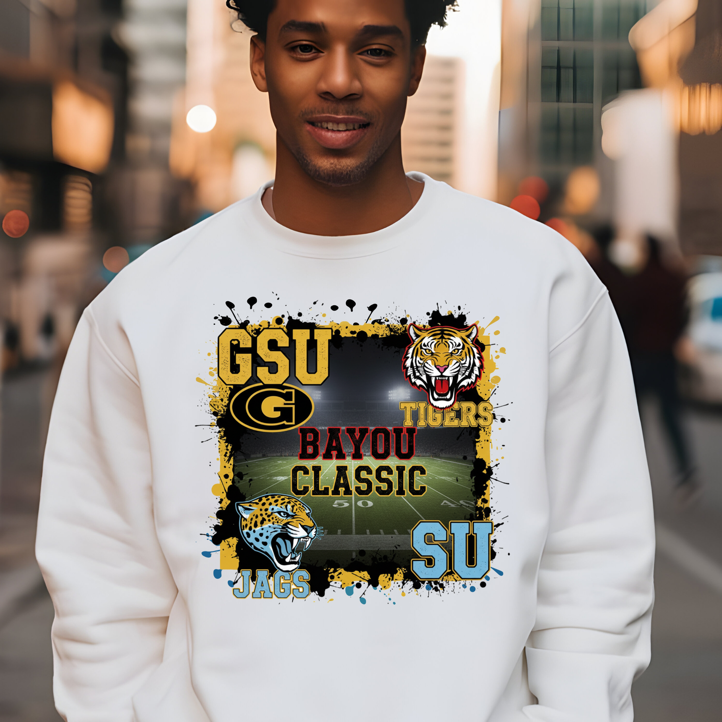 Person wearing a white sweatshirt with sports team graphics and text. Bayou Classic Football Sweater - Grambling State GSU Tigers vs. Southern University SU Jags Sweater