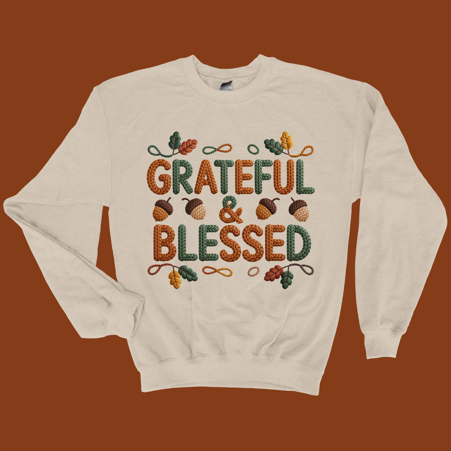 Beige sweatshirt with 'Grateful & Blessed' text and autumn-themed design on a brown background