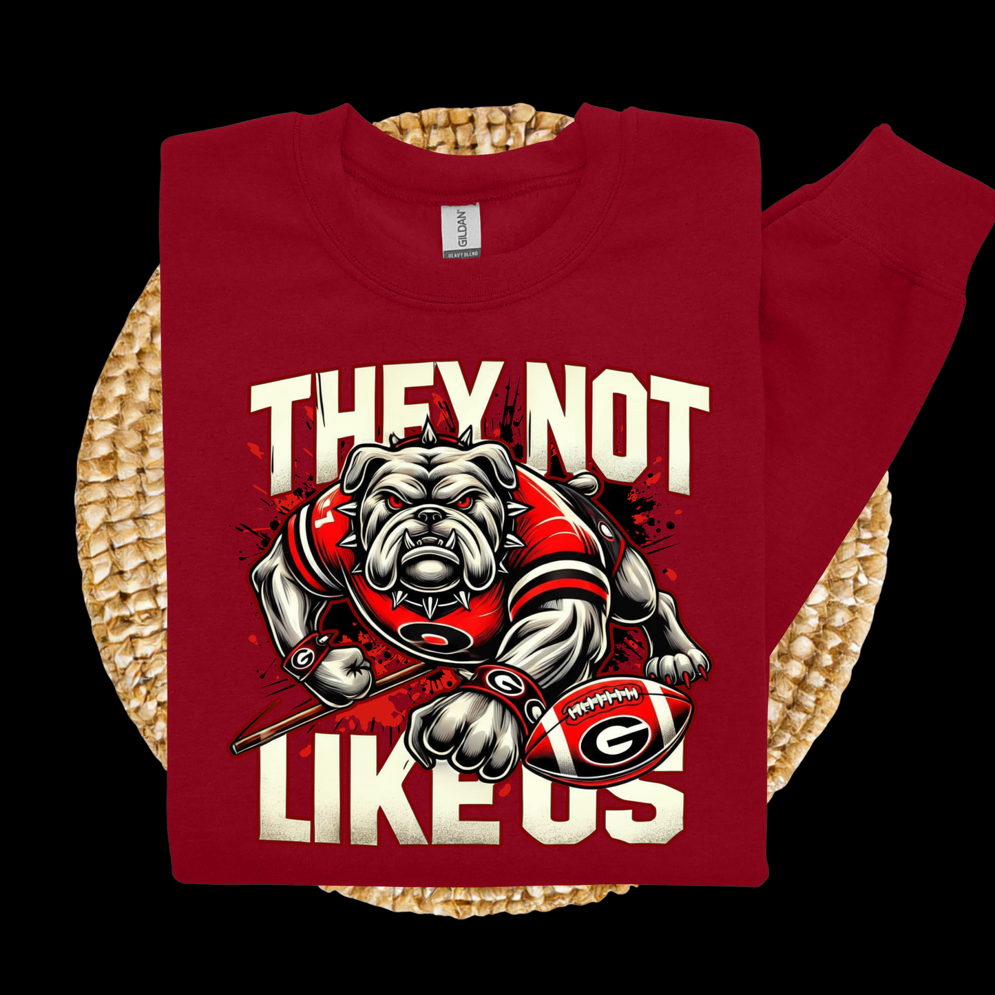 Red t-shirt with bulldog graphic and text on a woven surface