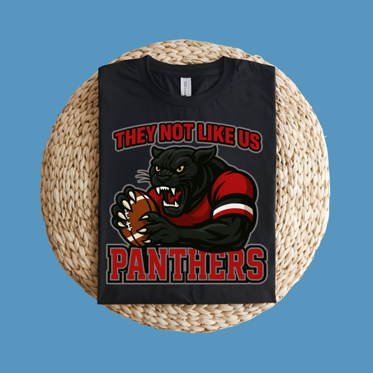 Black t-shirt with panther graphic and text on a woven surface Custom Mascot Shirt - Panthers They Not Like Us Game Day Wear