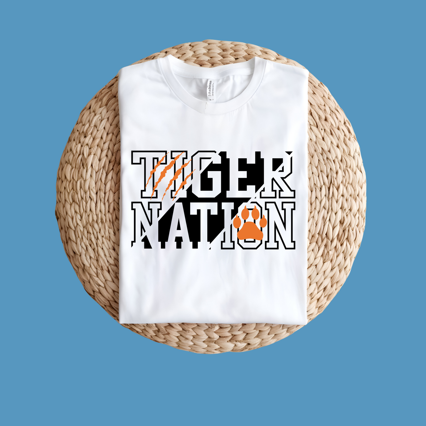 White sweatshirt with 'Tiger Nation' text and paw print on a woven mat - Custom Mascot Shirt - Tiger Nation - School Spirit Tee Shirt
