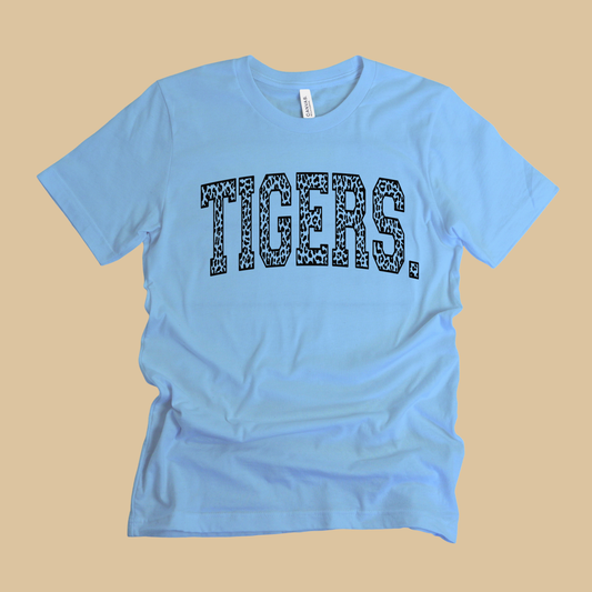 Light blue t-shirt with 'TIGERS' printed in black on a beige background Custom Mascot Shirt - Tigers Leopard Varsity Typography Game Day T-Shirt