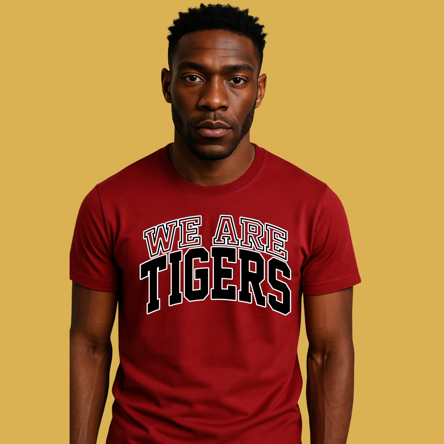 Man wearing a red 'WE ARE TIGERS' t-shirt on a yellow background Custom Mascot Shirt - We Are Tigers Game Day Spirit Wear