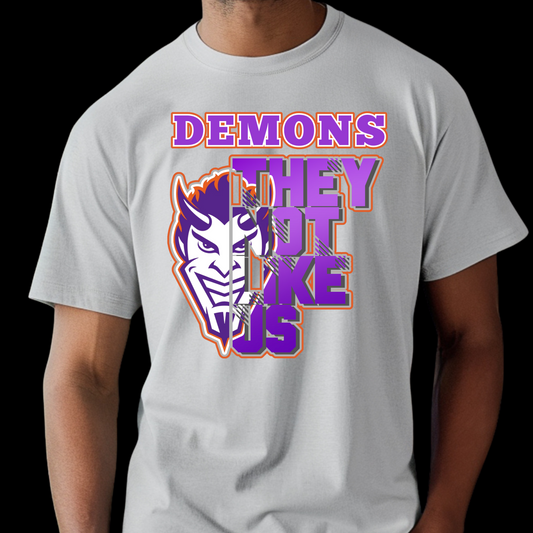 Gray t-shirt with a graphic design featuring a demon face and text on a black background NSU Demons T-Shirt- Demons They Not Like Us Game Day Graphic Tee
