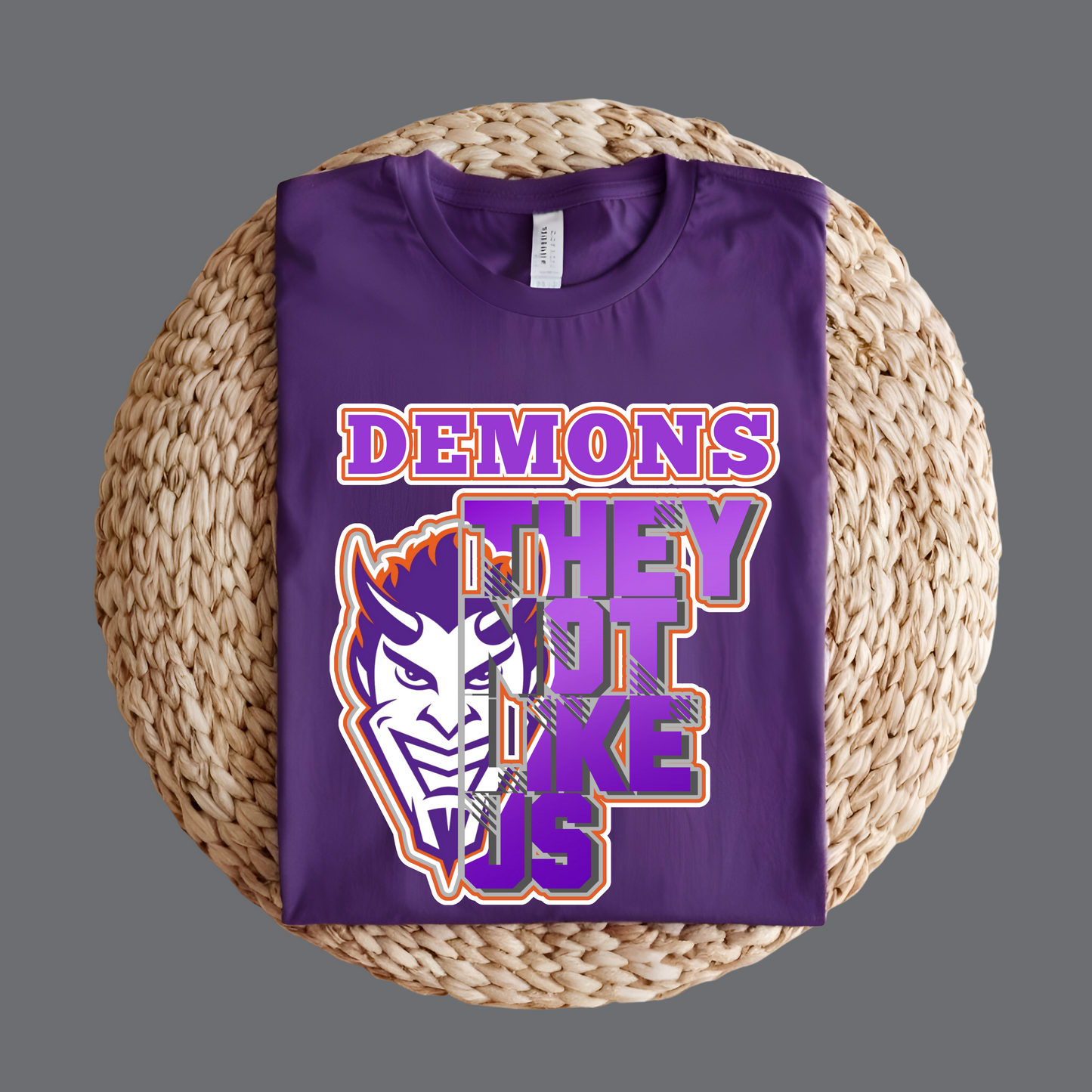 Purple t-shirt with graphic design and text on a woven surface NSU Demons T-Shirt- Demons They Not Like Us Game Day Graphic Tee