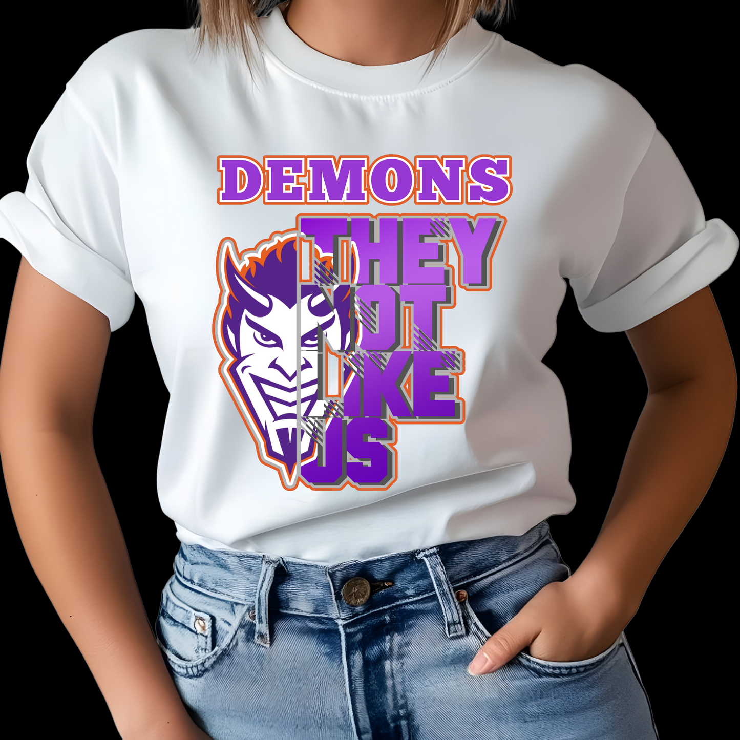 Person wearing a white t-shirt with a graphic design and text. NSU Demons T-Shirt- Demons They Not Like Us Game Day Graphic Tee