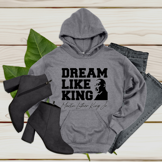 black women wearing a white hoodie with the phrase "DREAM LIKE KING" and an image of Martin Luther King Jr., celebrating Black heritage and empowerment.