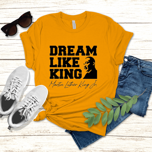 black men wearing a white shirt with the phrase "DREAM LIKE KING" and an image of Martin Luther King Jr., celebrating Black heritage and MLK Birthday with a t-shirt