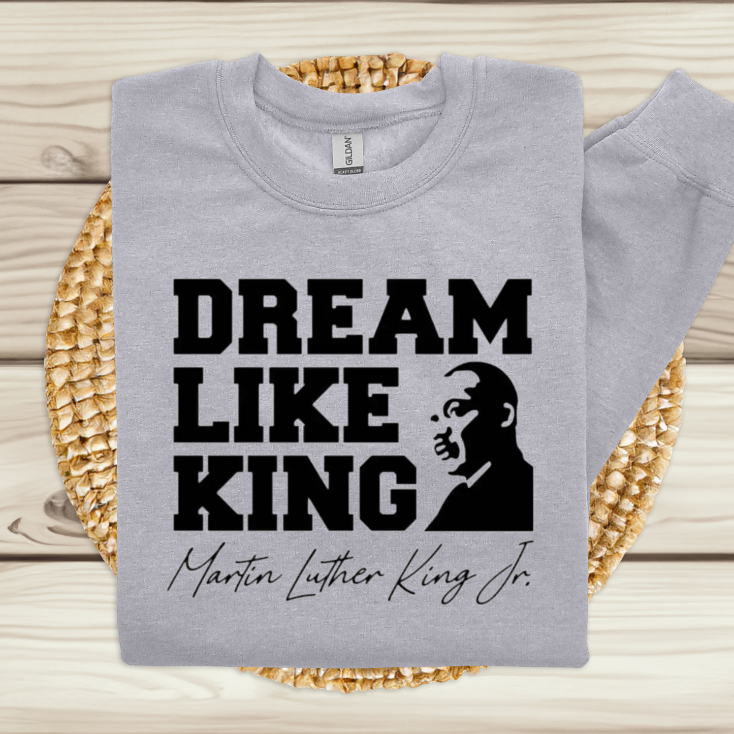 Black women wearing a black sweatshirt with the phrase "DREAM LIKE KING" and an image of Martin Luther King Jr., celebrating Black heritage and empowerment for MLK Birthday Celebration and holiday