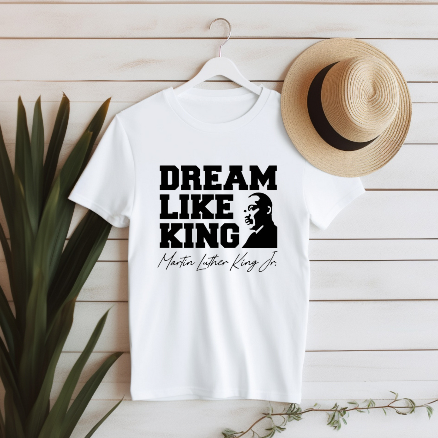 Person wearing a white shirt with the phrase "DREAM LIKE KING" and an image of Martin Luther King Jr., celebrating Black heritage and MLK Birthday with a t-shirt