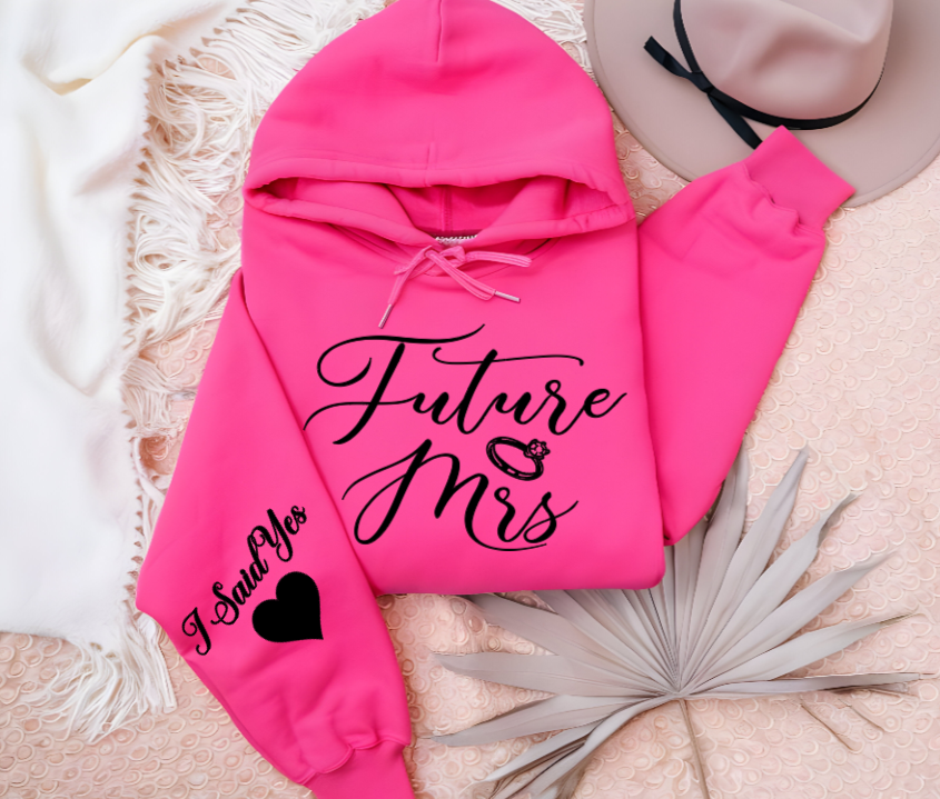 Women's pink hoodie with Future Mrs. to indicate engagement Announcement keepsake sweater for the bride to be in addition to a perfect engagement gift at the bridal, a personalized wedding shirt with I said yes on the sleeve