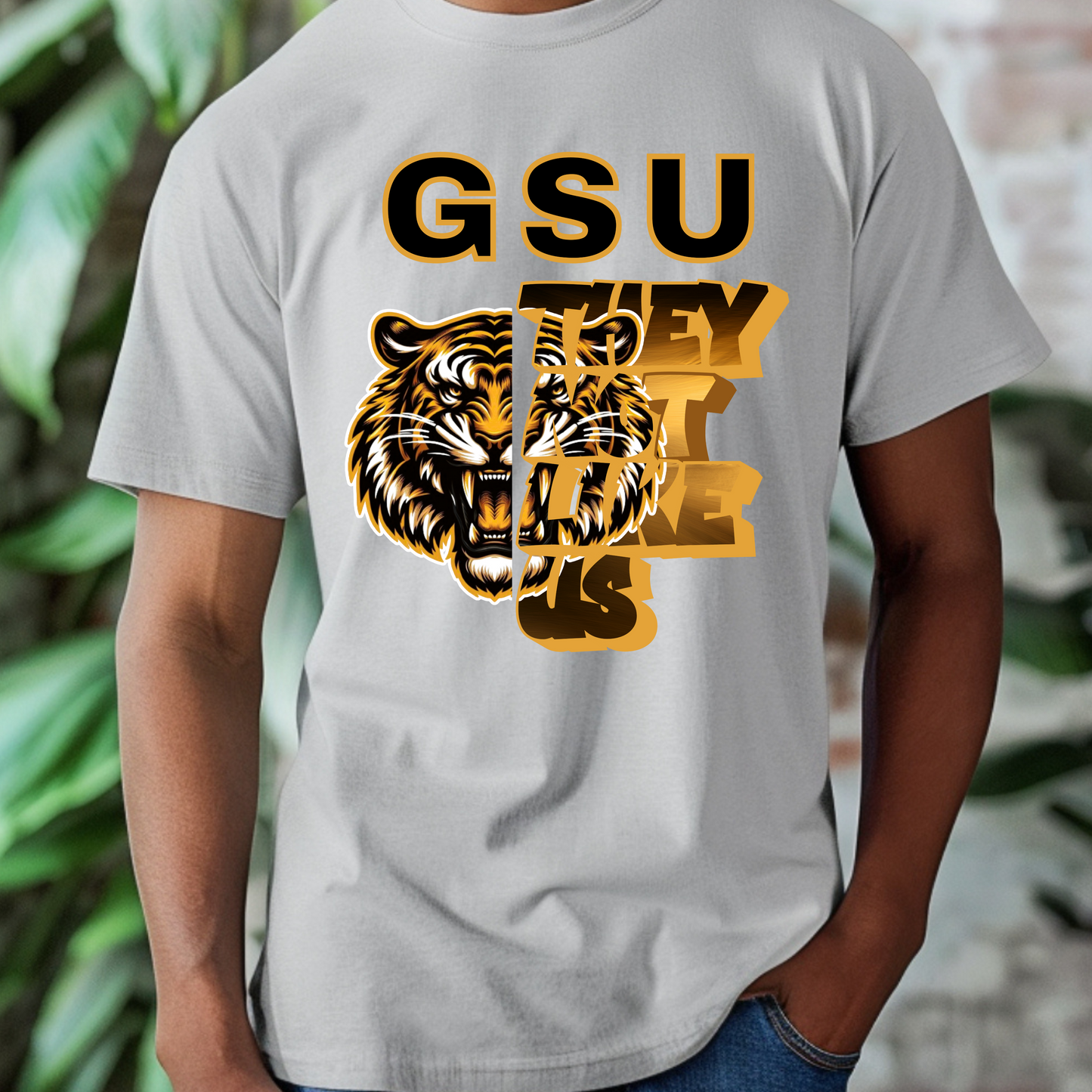 Gray t-shirt with tiger graphic and 'GSU THEY LIKE US' text on a blurred background Grambling State Tigers T-Shirt - They Not Like Us - Game Day Statement Tee