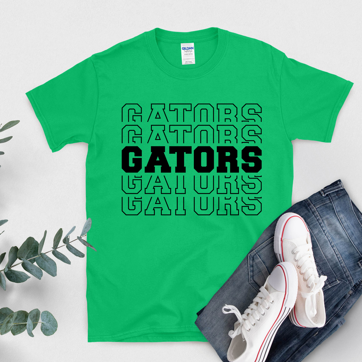 Green t-shirt with 'GATORS' text, white sneakers, and jeans on a light gray background Gators Mascot Shirt - Gators Pride Game Day Ready Cool Tee