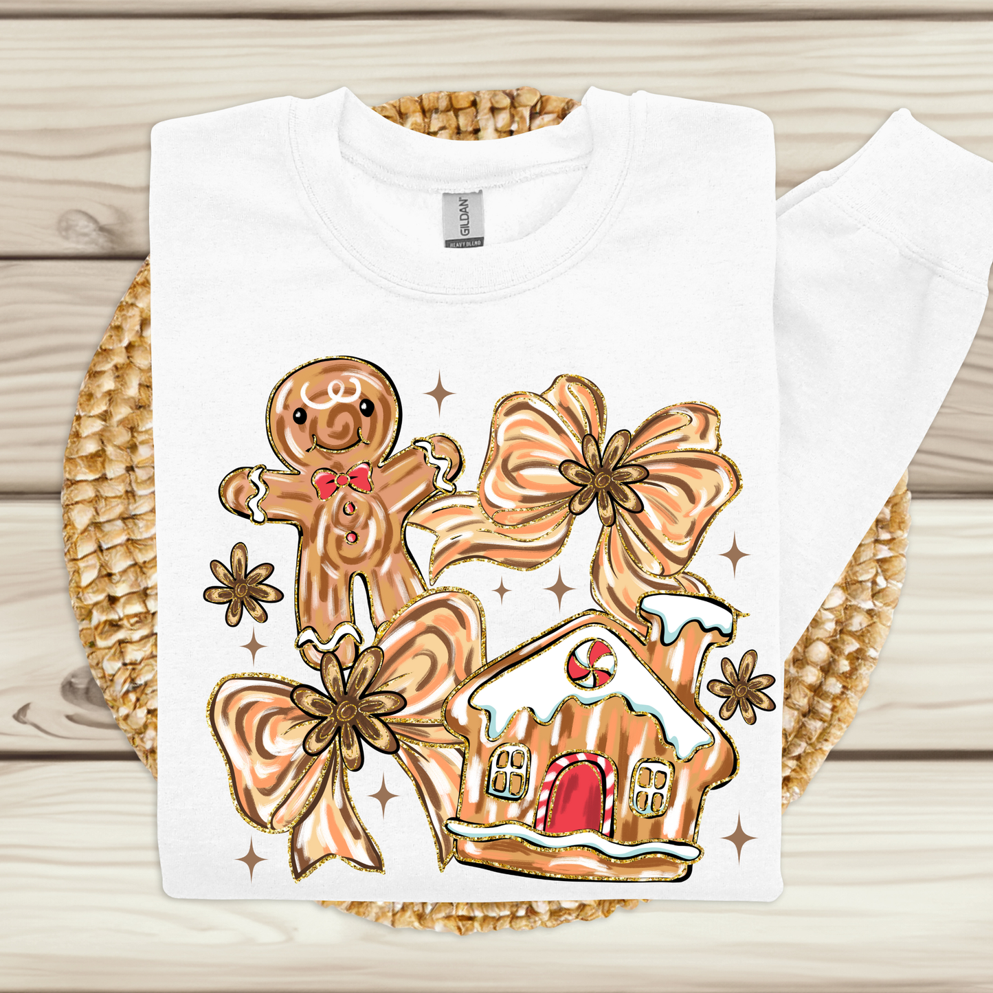 White t-shirt with a gingerbread-themed design on a woven mat.