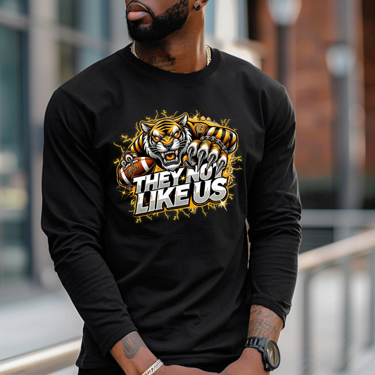 Person wearing a black long-sleeve shirt with a tiger graphic and text outdoors.