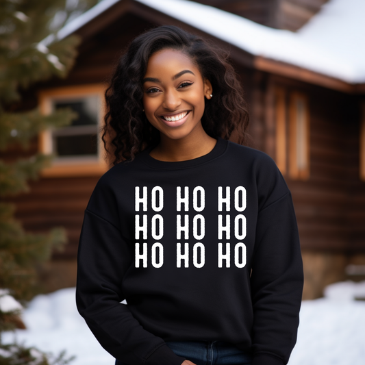 Person wearing a black sweatshirt with 'HO HO HO' text in front of a wooden cabin.