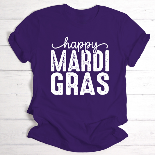 Purple t-shirt with 'happy MARDI GRAS' text on a white wooden background