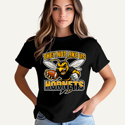 Person wearing a black t-shirt with a Hornets logo and text. Hornets Mascot Shirt - Bold Hornets They Not Like Us Game Day Spirit Tee