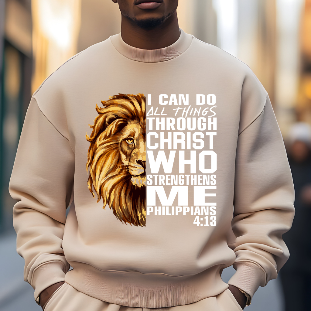 Lion Christian Sweatshirt "I Can Do All Things Through Christ" Unisex Man wearing a beige Christian faith sweater with "I can do all things through Christ who strengthens me" and Lion of Judah design. Inspirational Christian sweatshirt