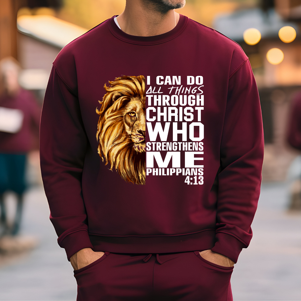 Lion Christian Sweatshirt "I Can Do All Things Through Christ" Unisex Man wearing a Maroon Christian faith sweater with "I can do all things through Christ who strengthens me" and Lion of Judah design. Inspirational Christian sweatshirt