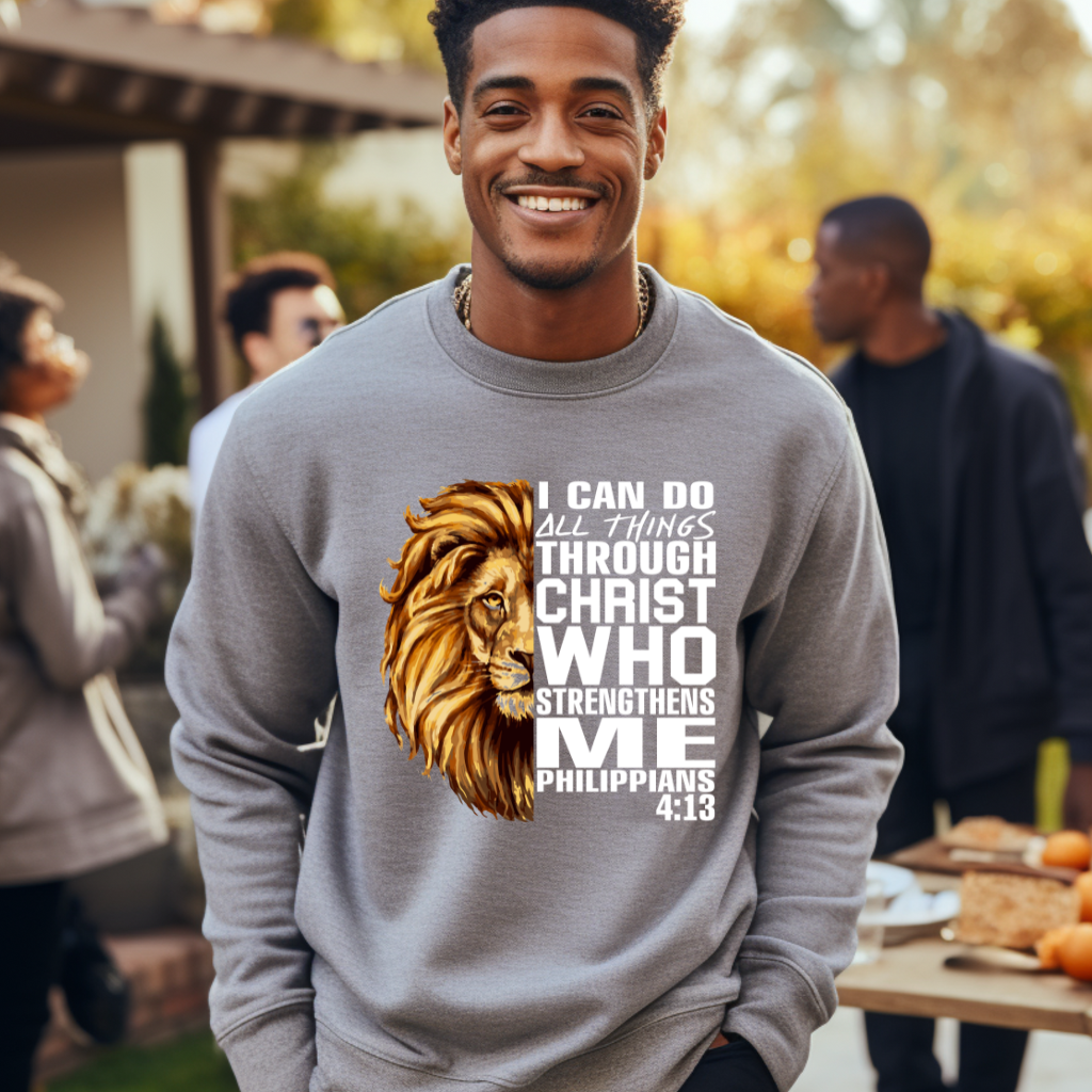Lion Christian Sweatshirt "I Can Do All Things Through Christ" Unisex Man wearing a grey Christian faith sweater with "I can do all things through Christ who strengthens me" and Lion of Judah design. Inspirational Christian sweatshirt
