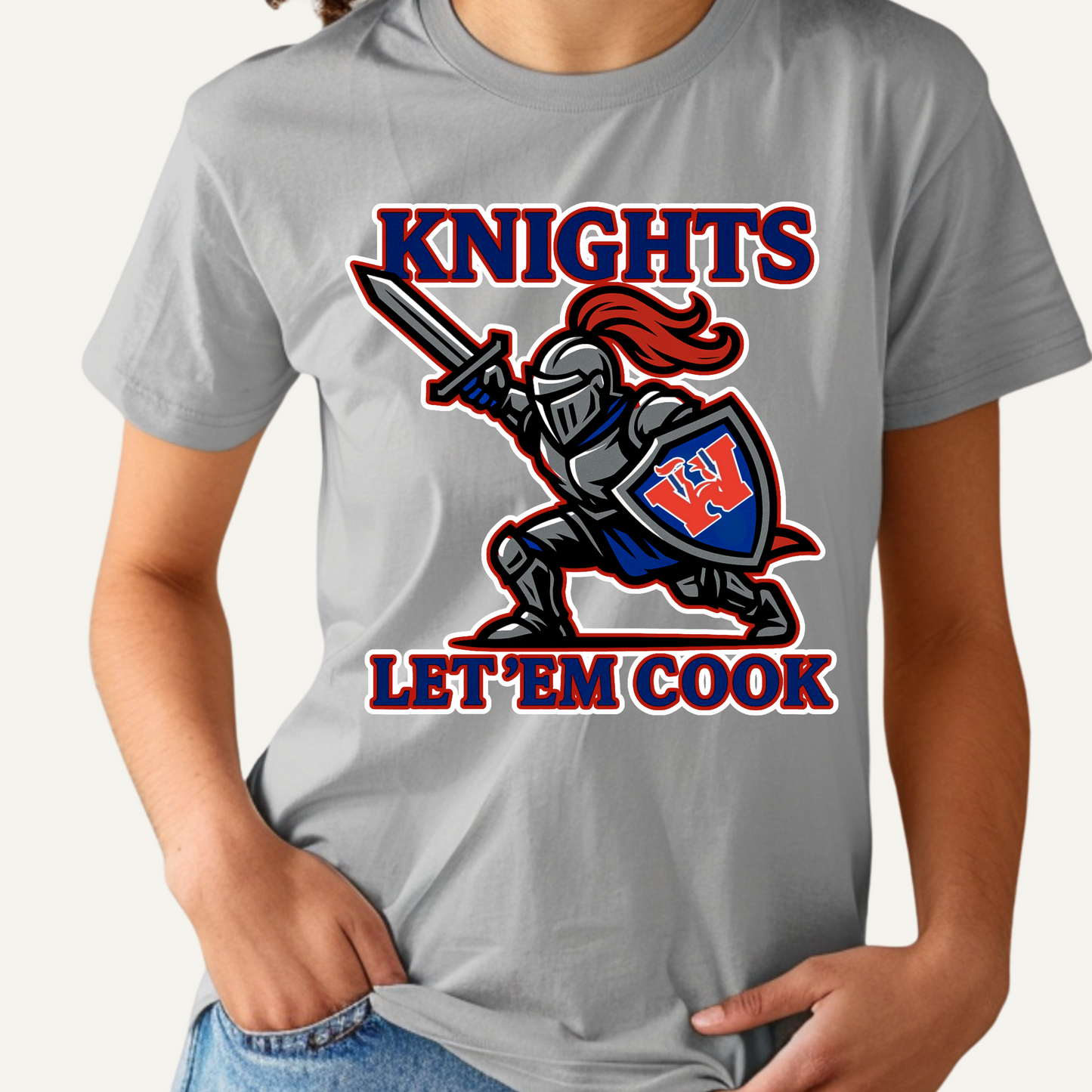 Gray t-shirt with a knight graphic and 'Knights Let 'Em Cook' text on a white background Woodlawn Knights Shirt: "Let'em Cook" Bold Game Day T-Shirt