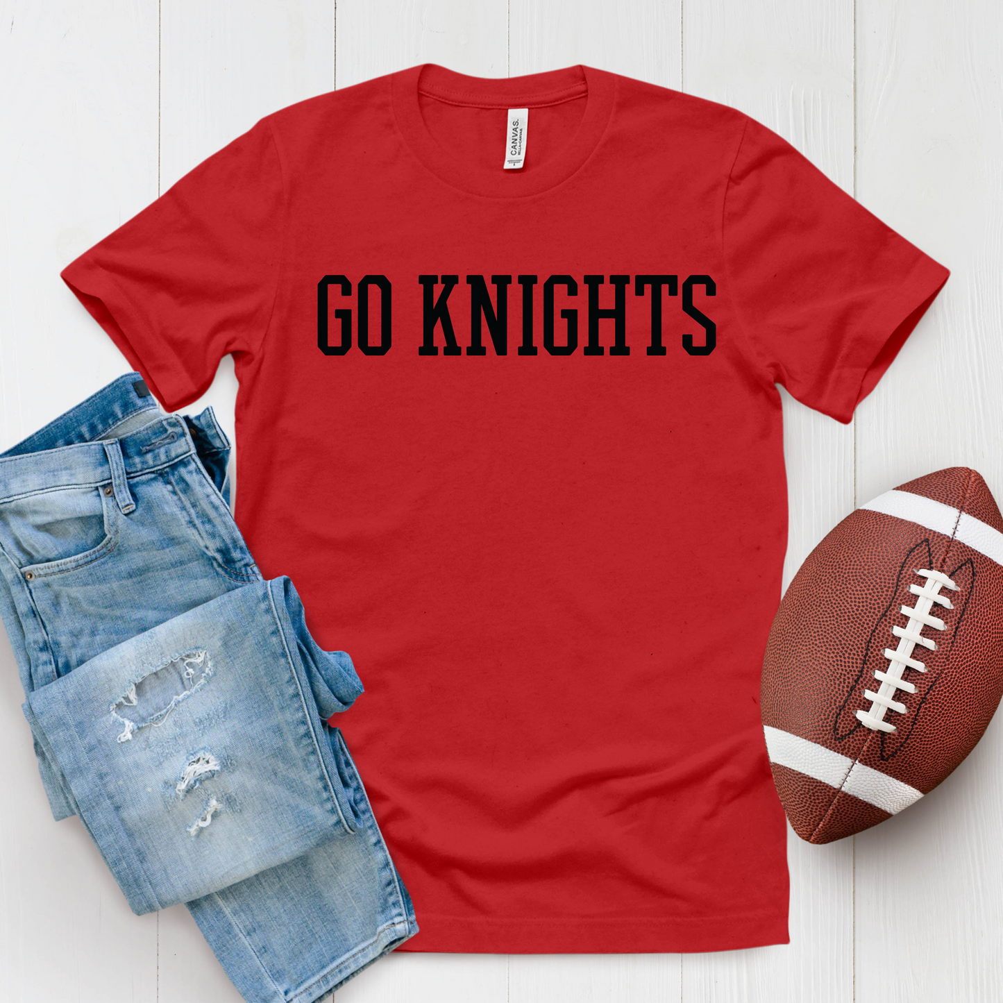 Red t-shirt with 'GO KNIGHTS' text, blue jeans, and football on a white background Knights School Spirit Shirt - Go Knights - School Pride T-Shirt
