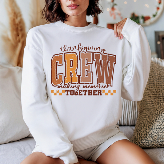 Person wearing a white sweatshirt with 'Thanksgiving CREW making memories Together' text.