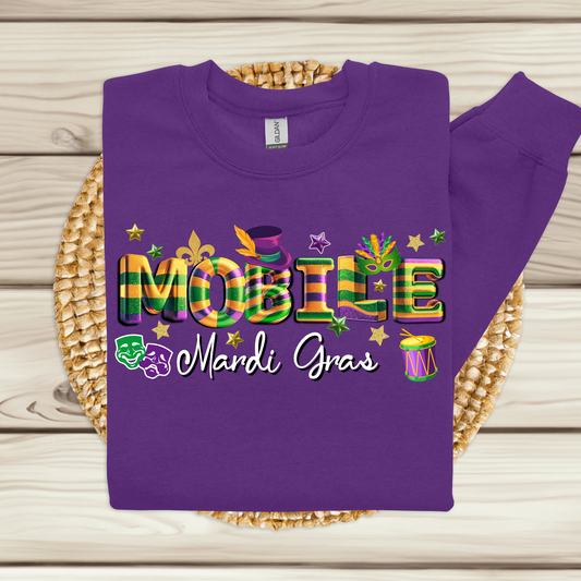 Purple sweatshirt with colorful 'MOBILE Mardi Gras' text on a woven mat.