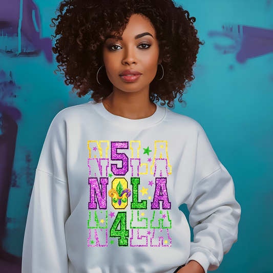 Woman wearing a white sweatshirt with colorful text against a blue background