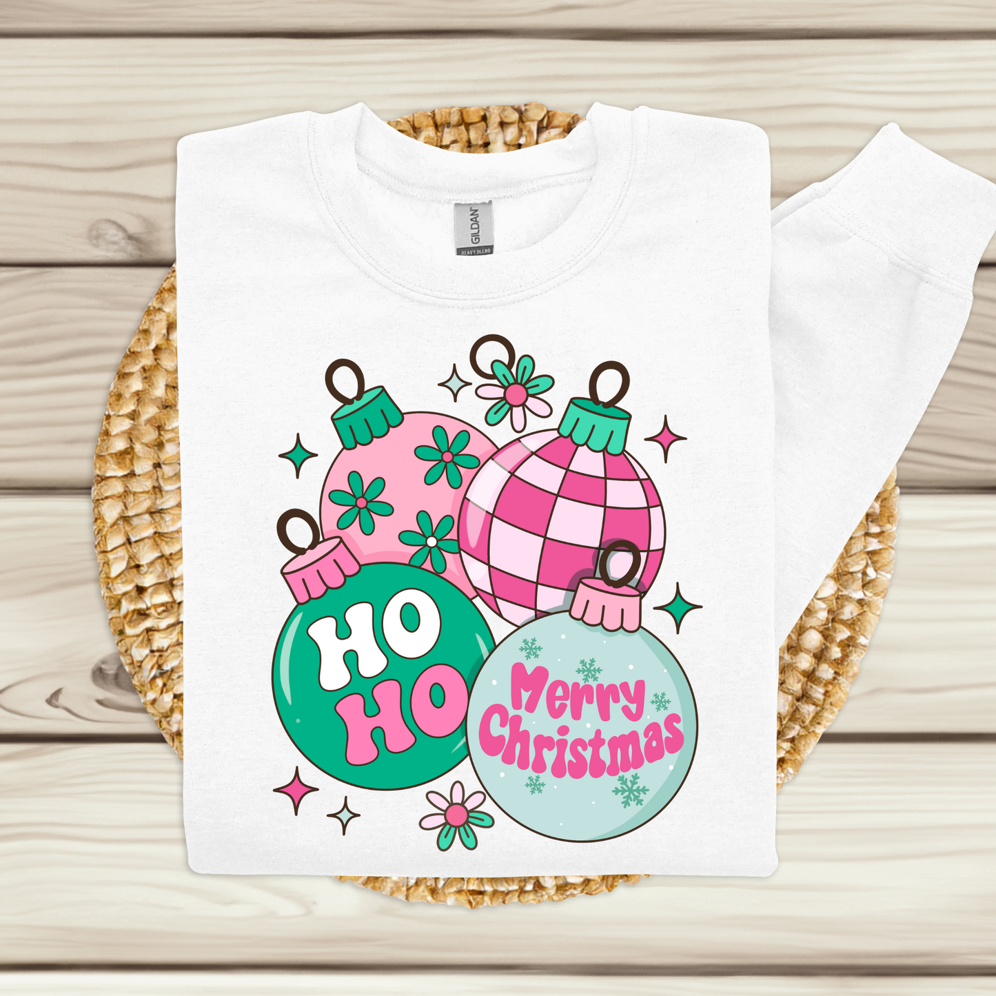 White t-shirt with Christmas-themed design on a woven mat