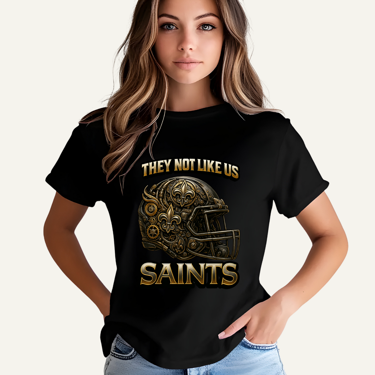 Person wearing a black t-shirt with gold graphics and text on a plain background Saints Mascot Shirt - Saints They Not Like Us Game Day Football Tee