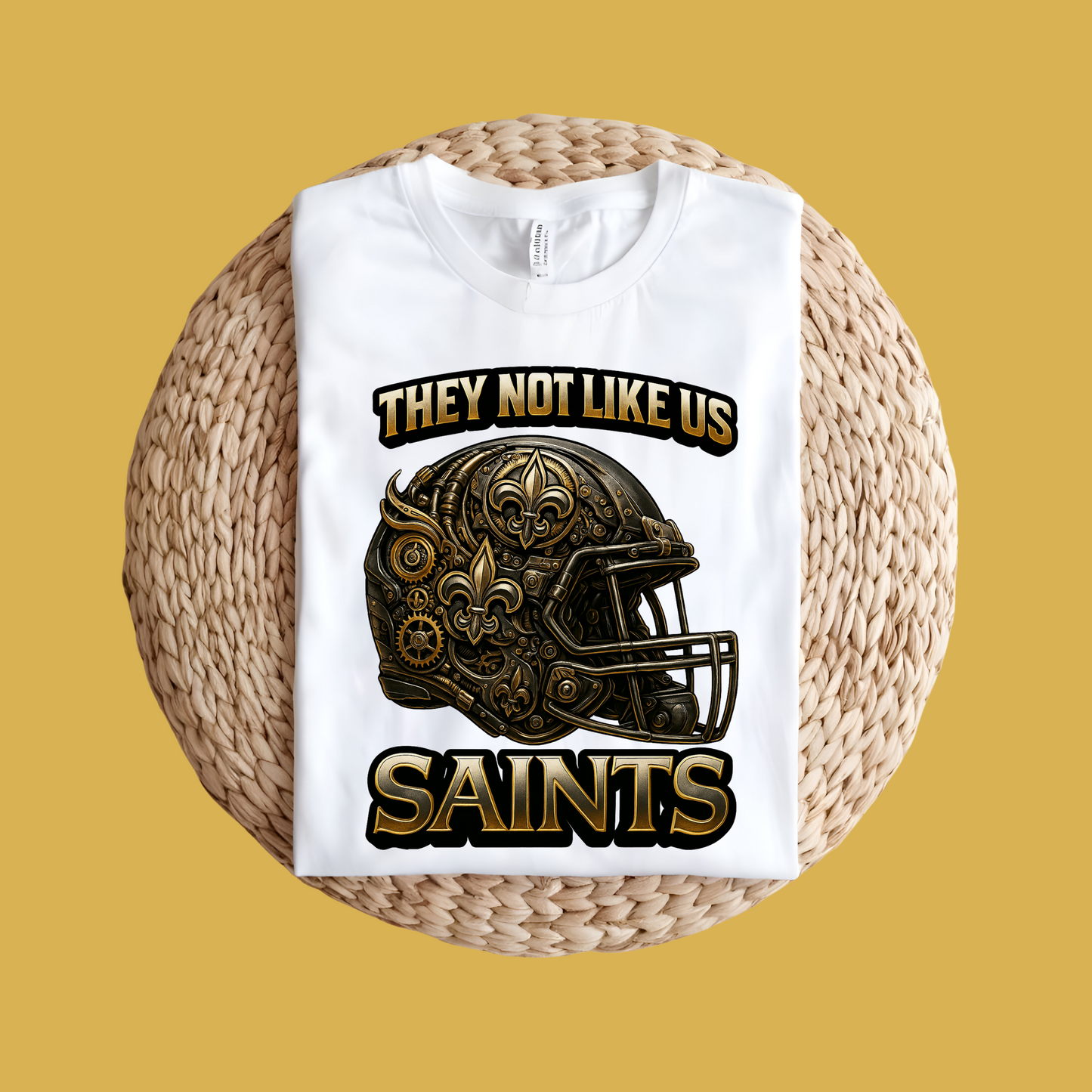 White sweatshirt with football helmet graphic and text on a woven ball against a yellow background Saints Mascot Shirt - Saints They Not Like Us Game Day Football Tee