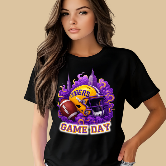 Person wearing a black t-shirt with a 'Tigers Game Day' design on a beige background Tigers Game Day Tee - Bold Fan Game Day Tigers Football T-Shirt